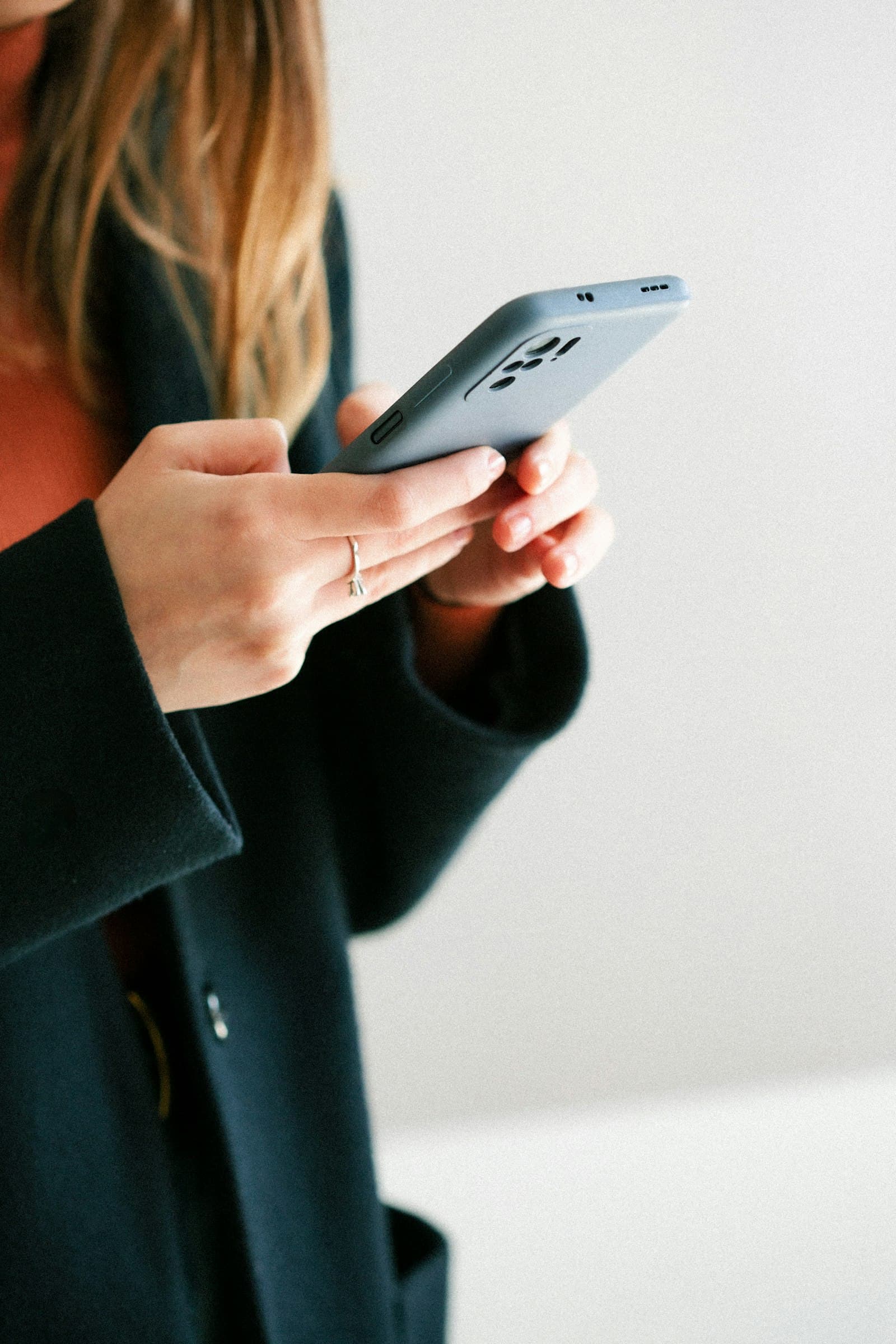 Close-up of a customer using a smartphone, representing localized WhatsApp conversations in Indian languages.